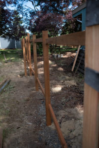 A line of posts and stringers all set and ready for pickets